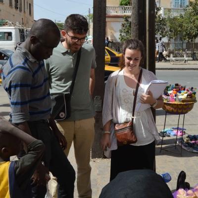 Projects Abroad interns speak to a local street vendor during their Human Rights work experience in Senegal. Students talk to a local street vendor during their Human Rights internship in Senegal.